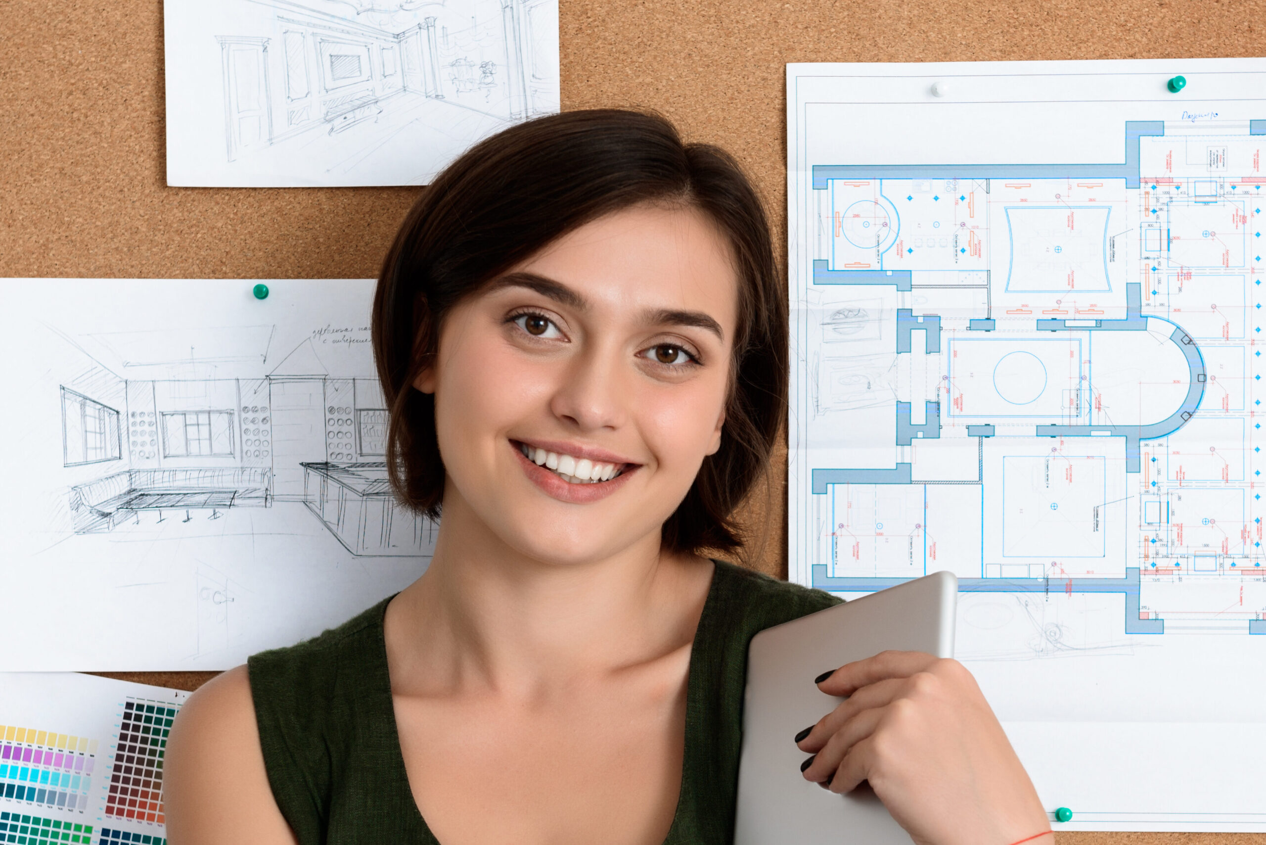 Home young beautiful businesswoman smiling, standing near desk with drawings. office background.